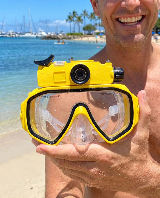 Customer holding the yellow Deep Dive Goggles at the beach