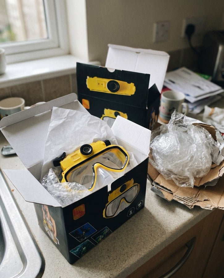 Yellow Deep Dive Goggles being unboxed on a kitchen bench