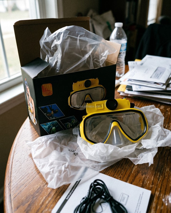 Yellow mask and box with a USB cable on a round table
